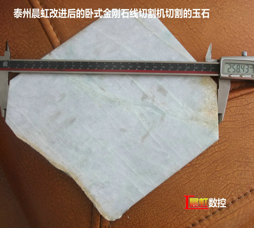 圖為泰州晨虹CHSX5650-XW型數(shù)控金剛石線切割機切割的玉石